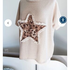 Chasing stars.  Latte colored leopard star.  Blouse is short in length